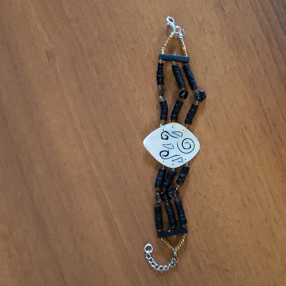 Engraved mother of pearl, shell, and bead Bali bracelet.